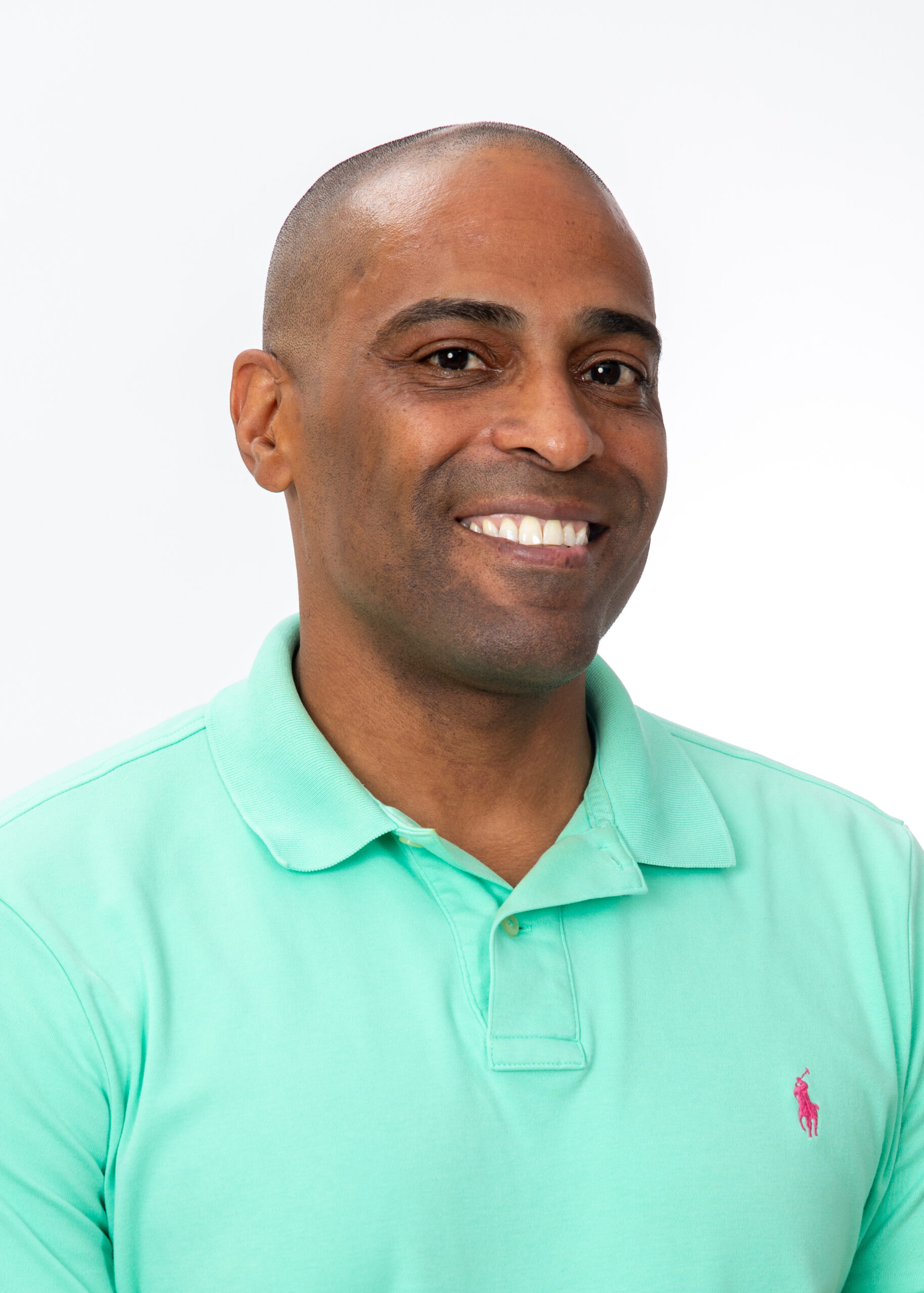 Smiling person wearing mint green polo shirt